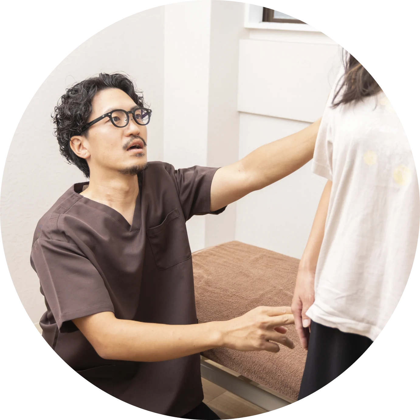 院長が患者の身体の状態を確かめながら施術している様子